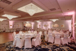 Atlantis Ballroom styled with pink lighting and decor.