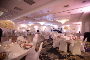 Ballroom with pink lighting and tables