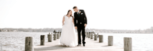 Bride and groom posed on the pier.