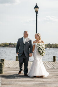 bride and groom posing at the pier