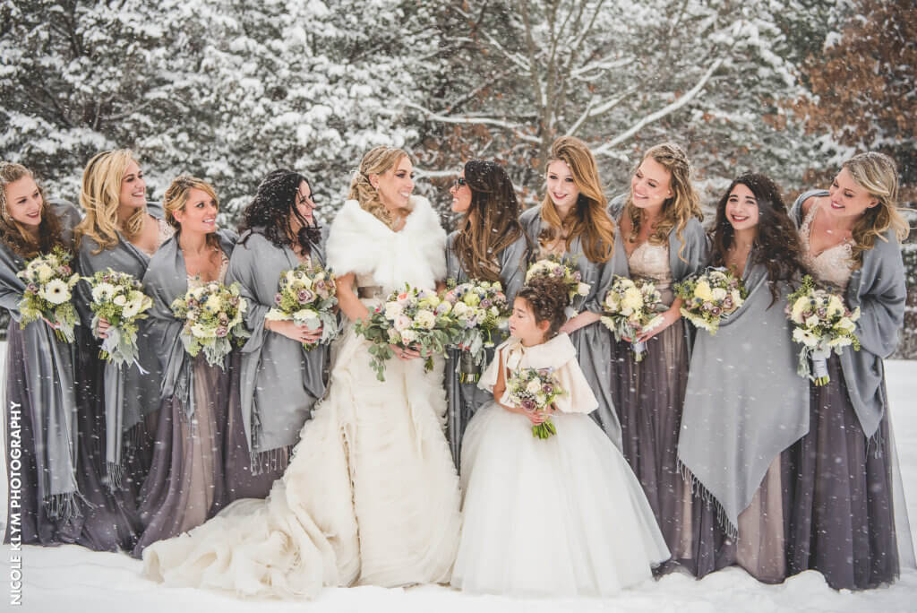 bride and bridesmaids posed in the snow