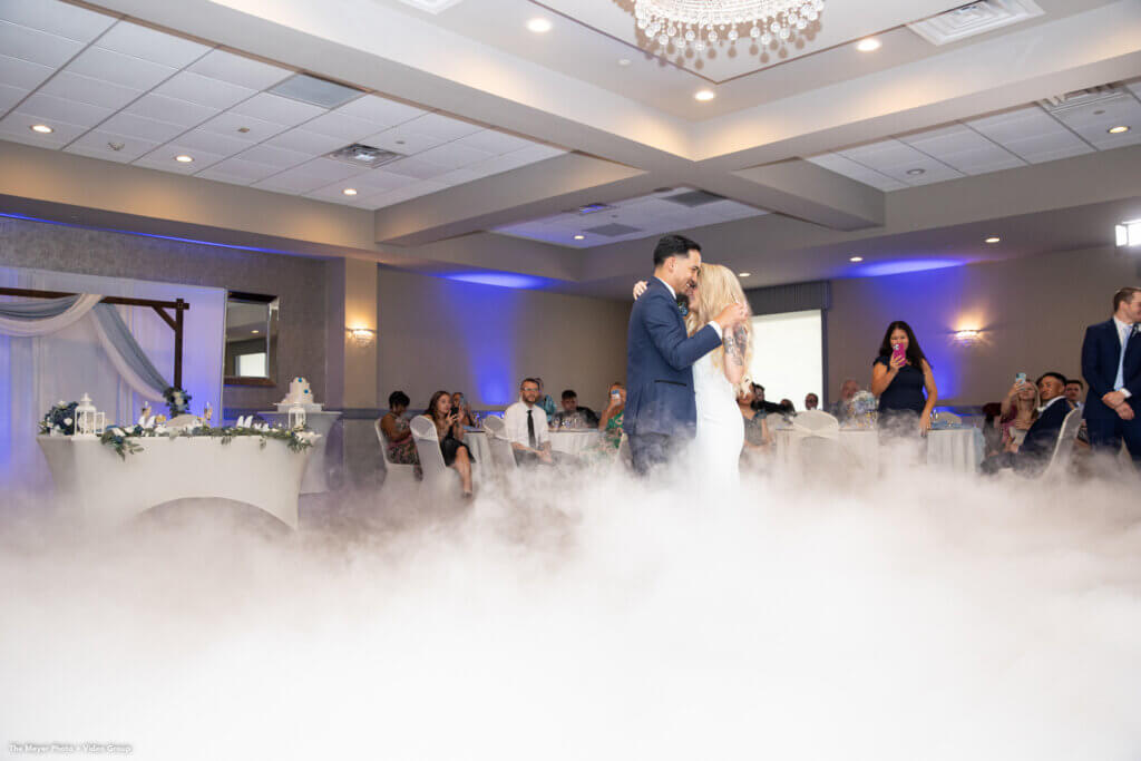 bride and groom dancing in a large ballroom